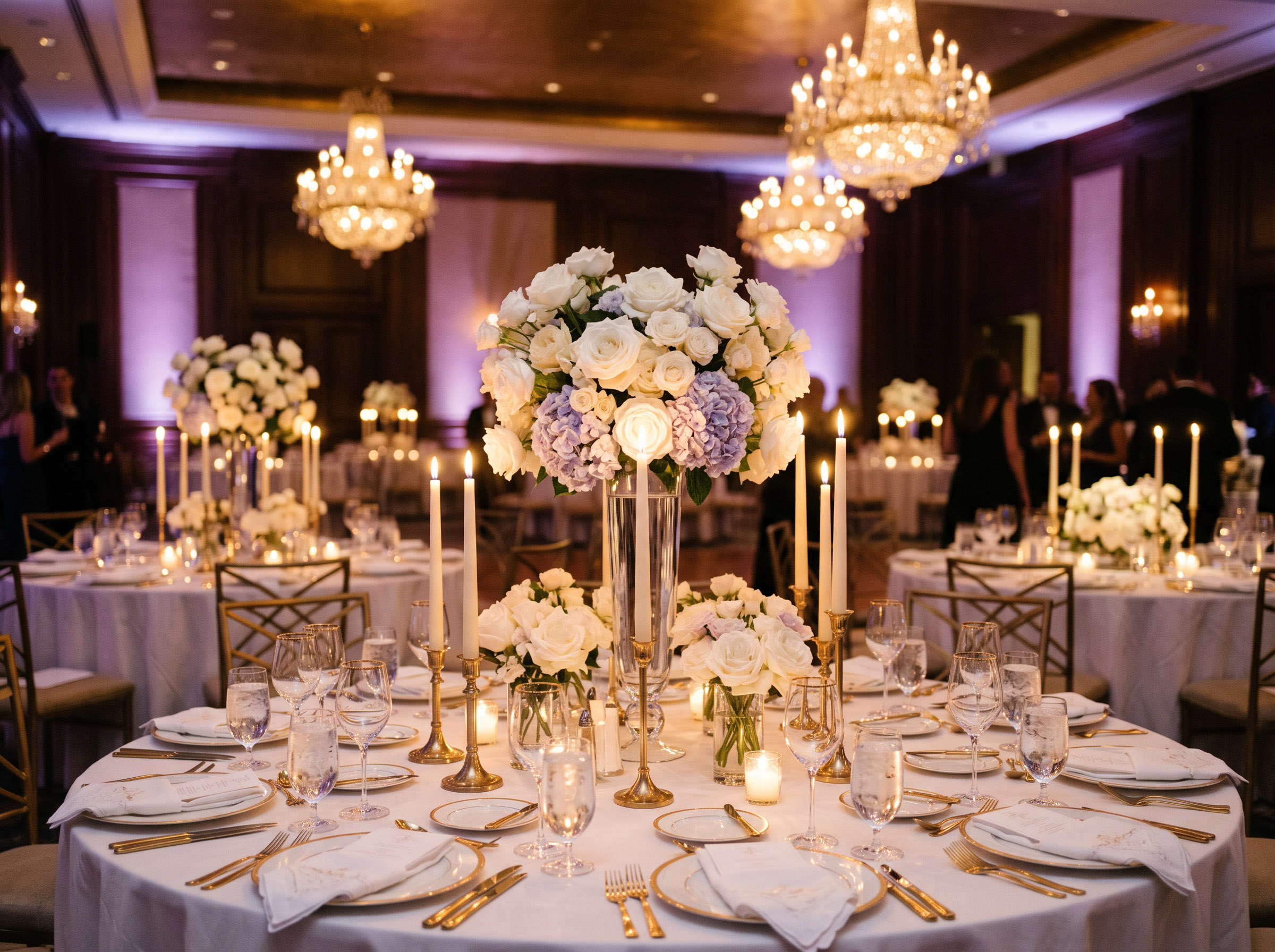 Candlelit gala tables with white flowers and chandeliers